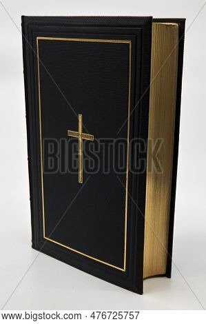 An Old Bound Bible With A Gold Cross Pressed Into The Leather. The Edges Are Finished With Real 24 K