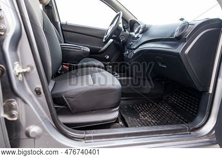 Interior View With Steeering Wheel And Dashboard Of Luxury Very Expensive New White Car Stands In Th