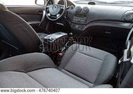 Interior View With Steeering Wheel And Dashboard Of Luxury Very Expensive New White Car Stands In Th