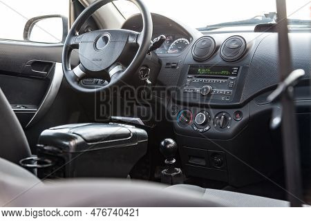 Interior View With Steeering Wheel And Dashboard Of Luxury Very Expensive New White Car Stands In Th