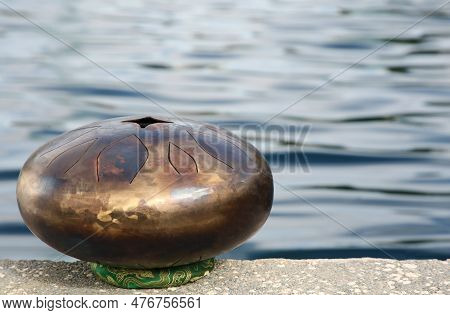 Steel Tongue Drum Near Sea, Space For Text. Percussion Musical Instrument