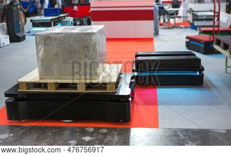 Autonomous Mobile Robot Transport Carton In Modern Warehouse. Smart Industry.
