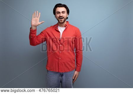 Well-groomed Caucasian Brunette 30s Man In A Red Shirt On A Background With Copy Space