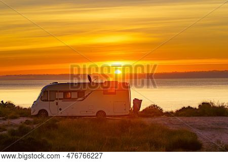 Sun Rising Over Sea Horizon And Camper Rv Camping On Beach Seashore. Holidays In Spain, Travel With 