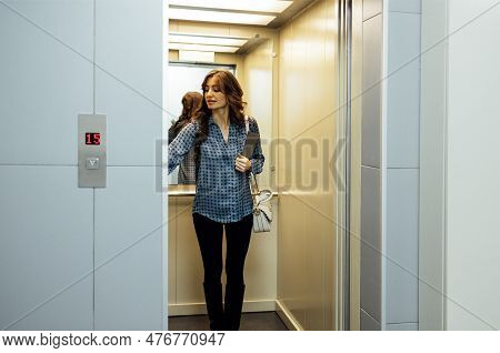 Young Attractive Woman In Casual Clothes And Bag Pushing Elevator Button In Residential Building Or 