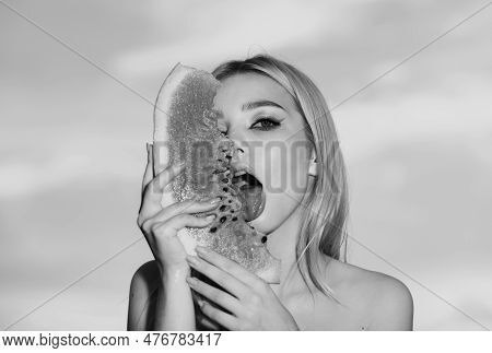 Sensual Young Woman Lick Watermelon With Sexy Tongue. Summer Taste. Cheerful Young Woman Holding Sli
