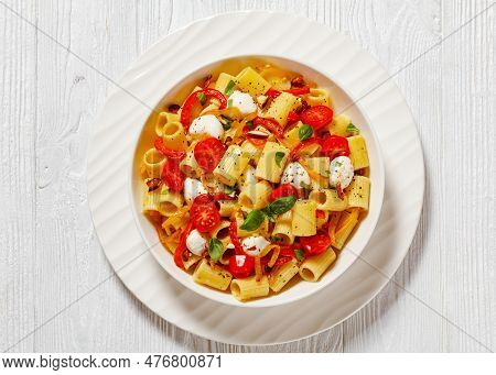 Roasted Pepper Tomato Mozzarella Pasta Salad In White Bowl On White Wood Table, Horizontal View From