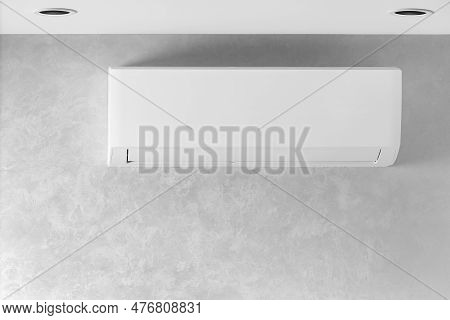White Air Conditioner On A Gray Wall In A House, Apartment, Copy Space. Air Conditioning System. The