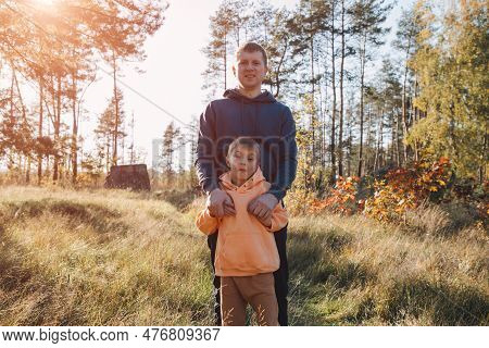 Happy Fathers Day. Dad And Son On A Walk In The Forest In Sunny Weather. Family Leisure. The Father 
