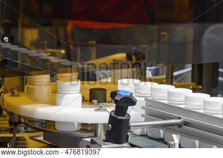 The Drug Filling Process In The Plastic Bottle. The Medical Manufacturing Process In Medical Factory