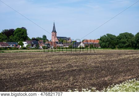 Tielrode, East Flemish Region, Belgium - May 18, 2023 - Fresh Plowed Soil With Plantation With The C