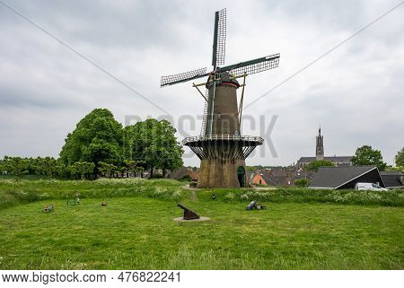 Hulst, Zeeland, The Netherlands - May 21, 2023 - Green Lawn With An Old Windmill