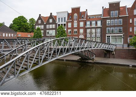 Hulst, Zeeland, The Netherlands - May 21, 2023 - Pedestrian Bridge And Historical Buildings At The W