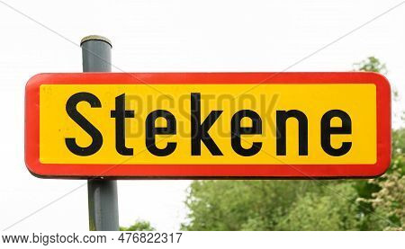 Stekene, East Flemish Region, Belgium - May 21, 2023 - Red And Yellow Road Sign Of The Village Of St