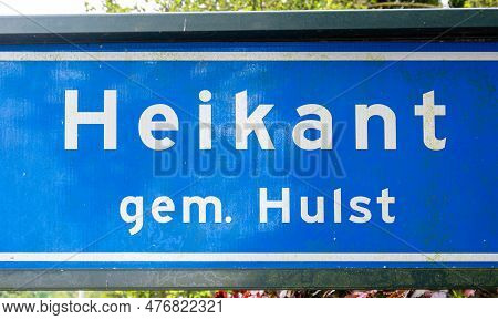 Heikant, Zeeland, The Netherlands - May 21, 2023 - Blue Road Sign Of The Village Of Saint Jansteen, 