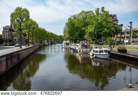 Lokeren, East Flemish Region, Belgium - May 18, 2023 - Pleasure Ships At The Green Banks Of The Rive