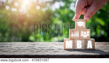 Mba, Master Of Business Administration Education Concept, Hand Holding Wooden Block With Master Of B