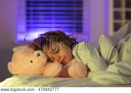 Good Night Sleep. Adorable Kid Sleeps In Bed With A Toy Teddy Bear. Sleeping Child.