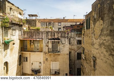 Facade In An Inner Courtyard In Old Town Centro Storico Of Italian Metropole Naples. Balconys And Wi