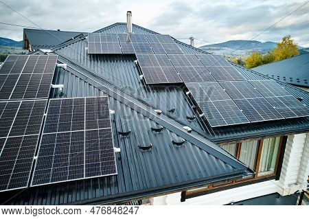 Photovoltaic Solar Panel System On The Roof Of House. Modern Solar Modules Installed On House. Conce