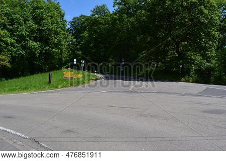 Country Road Intersection With Many Traffic Signs