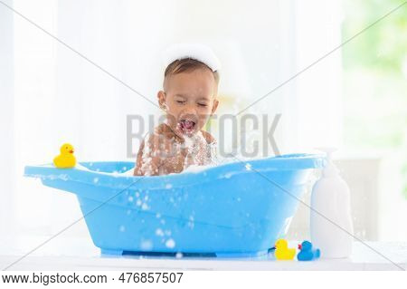 Baby Boy In Bath. Mother Washing Infant Child.