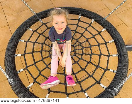 The Child Swings On A Swing Web.