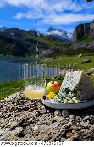 Pouring In Glass Of Natural Asturian Cider Made From fermented Apples, Asturian Cabrales Cow Blue Ch
