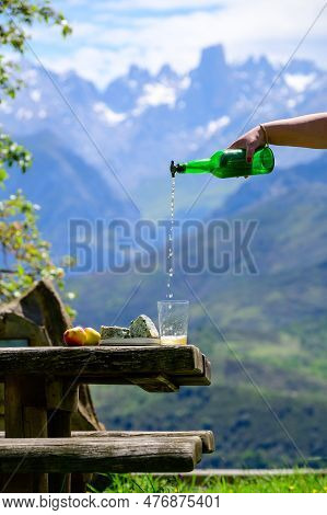 Pouring From High Height Of Natural Asturian Cider Made From fermented Apples, Asturian Cabrales Cow