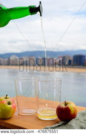 Pouring Of Natural Asturian Cider Made From fermented Apples In Wooden Barrels Should Be Poured From