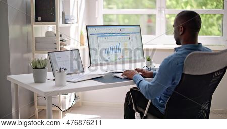 Data Analyst African Man Using Spreadsheet On Computer