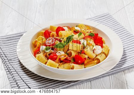 Roasted Pepper Tomato Mozzarella Pasta Salad In White Bowl On White Wood Table, Horizontal View From