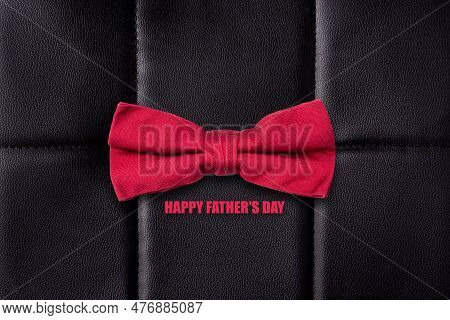 Happy Father's Day. Red Bow Tie, And Words On A Black Leather Background. Fathers Day Concept. Festi
