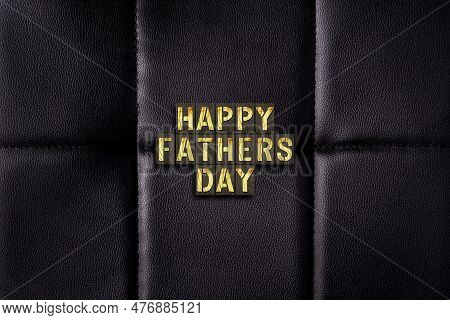 Happy Father's Day.wooden Words On A Black Leather Background. Fathers Day Concept. Festive Backgrou
