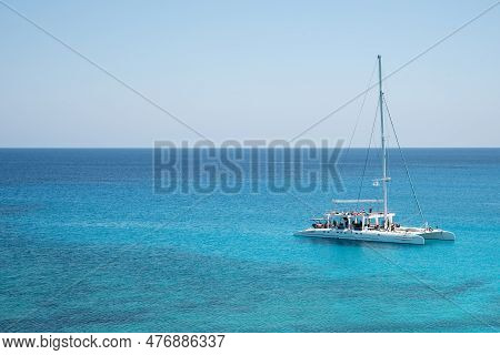 Tourist Yacht Sailing In The Sea With Tourists Enjoying Summer Holidays. Summer Vacations. Cape Greg