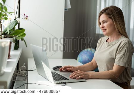 Successful Female Grapic Designer Watching Tutorial About Creative Ideas At Laptop Computer During W