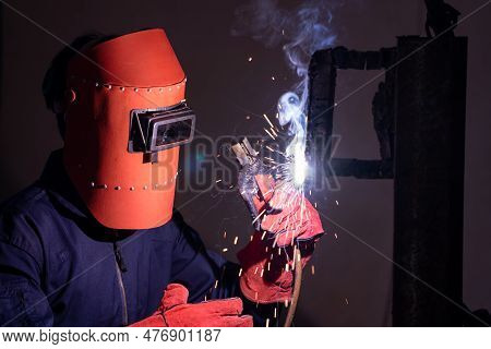 Metal Welding Steel Works Using Electric Arc Welding Machine To Weld Steel At Factory. Metalwork Man