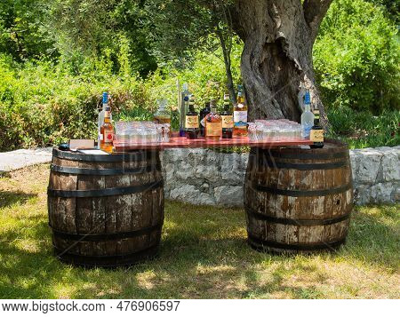Budva, Montenegro - 11 June 2022: Alcoholic Bar At A Party Outdoor In Sunny Summer Day. Bottle Of Wi
