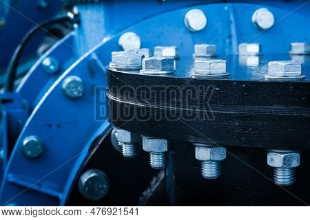 Large Pipe Connection With A Large Number Of Bolts And Nuts Enclosed On It. Pipeline.