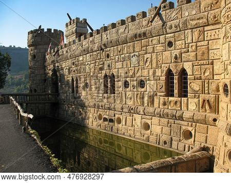 Facade Of Moussa Castle In Lebnon With A Pond Of Water.