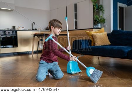 Little Boy Sweeping Floor In Living Room, Kid Doing Daily Regular Household Chores And Helping Paren