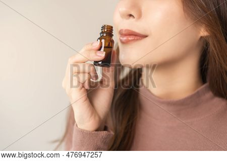 Aromatherapy, Attractive Asian Young Woman Hand Holding Bottle Of Essential Perfume Oil, Enjoying Sm