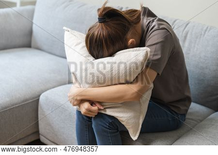 Mental Health, Depressed Sad Asian Young Woman, Girl Sitting On Sofa Or Couch, Cover Face With Pillo