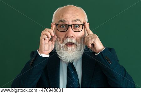 Surprised Professor. Education And Knowledge Concept. Elderly Professor, Teacher On Blackboard. Seni