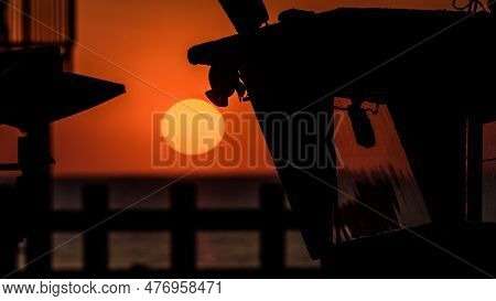 Sunset By The Sea - The Evening Sun Is Hiding Behind Horizon