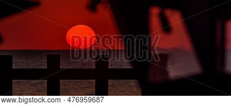 Sunset By The Sea - The Evening Sun Is Hiding Behind Horizon