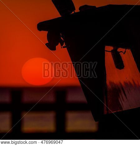 Sunset By The Sea - The Evening Sun Is Hiding Behind Horizon