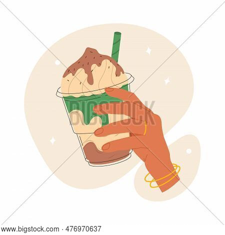 A Womans Hand Holds A Milkshake In A Plastic Glass With A Straw. Summer Sweet Cocktail With Cream. V