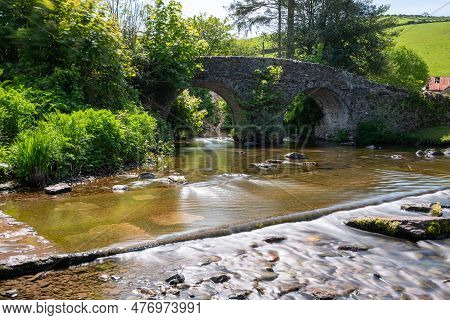 The Badgworthy Water River Flowing Under Malmsmead Bridge In Exmoor National Park