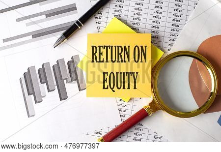 Return On Equity Text On Sticky On The Graph Background With Pen And Magnifier